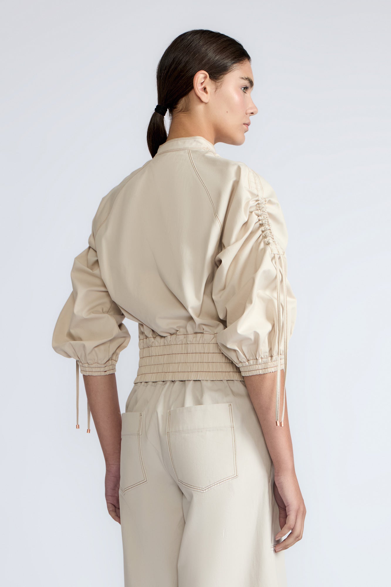 Zoe Jacket in Prestine – 100% cotton jacket with flap patch pockets, hidden buttons, long sleeves, and an adjustable drawstring hem.