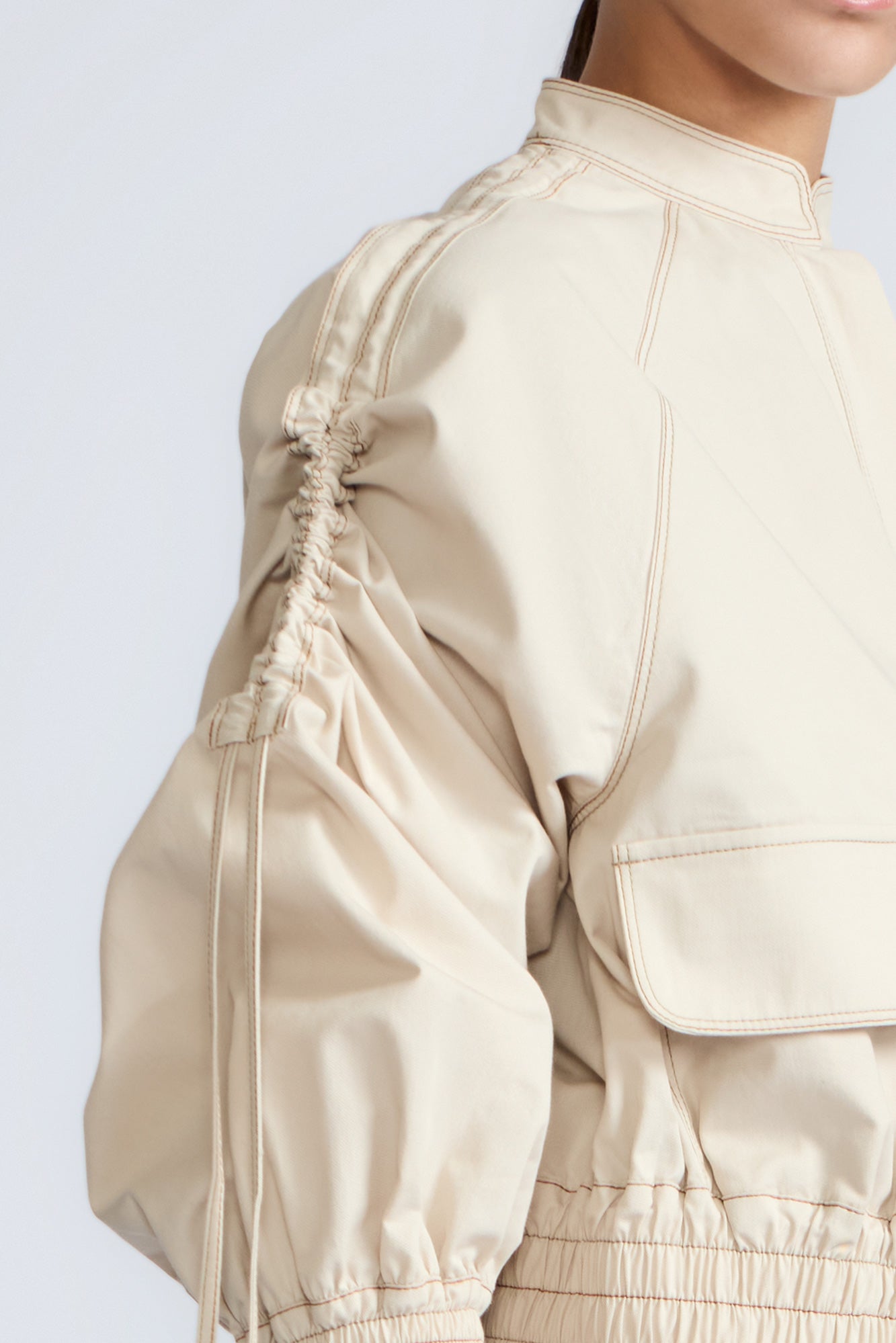 Zoe Jacket in Prestine – 100% cotton jacket with flap patch pockets, hidden buttons, long sleeves, and an adjustable drawstring hem.