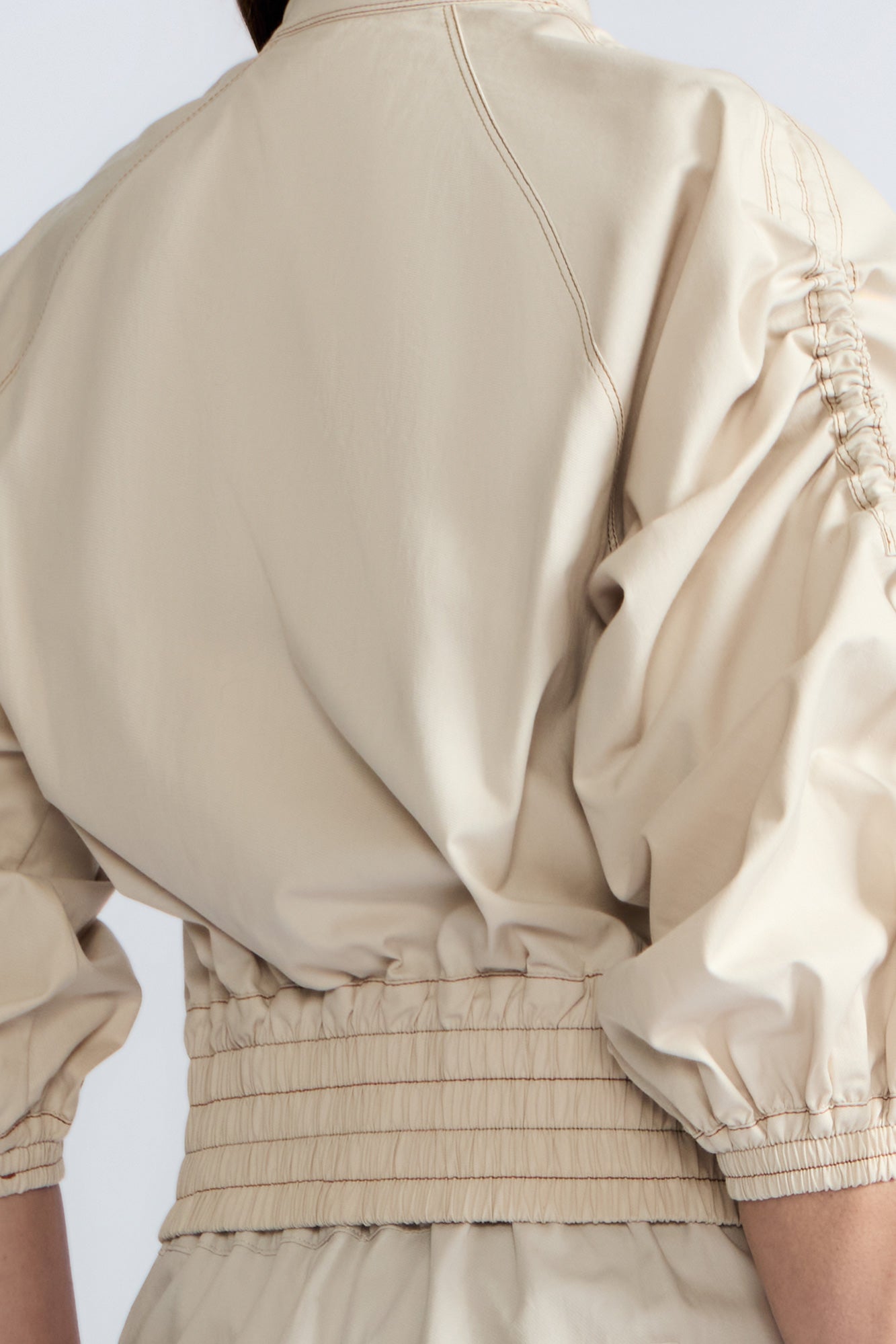 Zoe Jacket in Prestine – 100% cotton jacket with flap patch pockets, hidden buttons, long sleeves, and an adjustable drawstring hem.