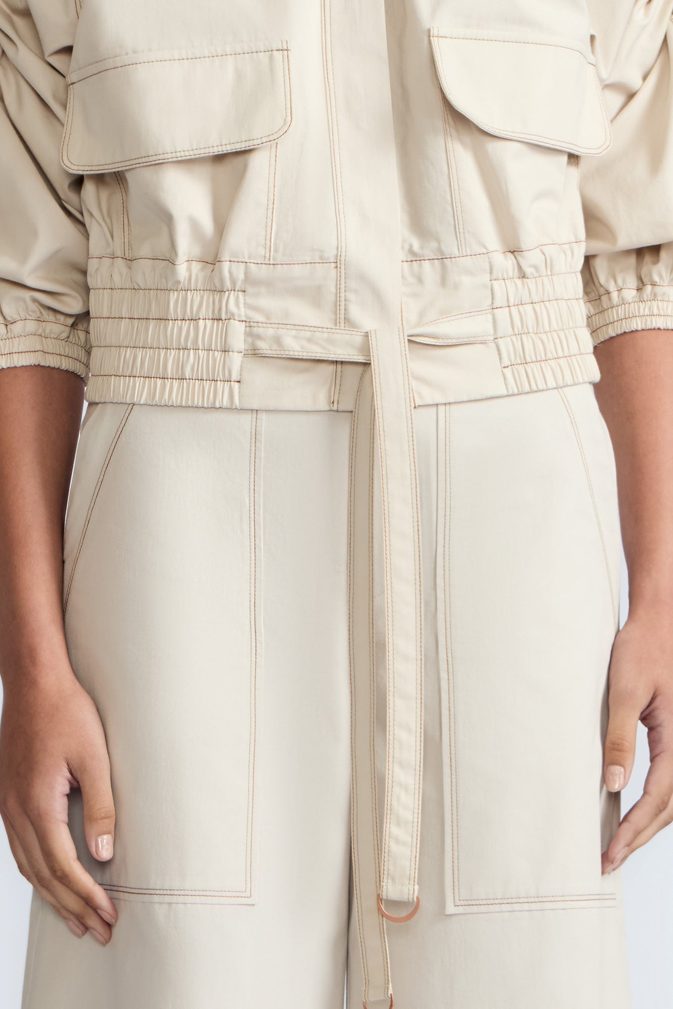 Zoe Jacket in Prestine – 100% cotton jacket with flap patch pockets, hidden buttons, long sleeves, and an adjustable drawstring hem.