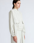 Zoe Jacket in Silver – 100% cotton jacket with flap patch pockets, hidden buttons, long sleeves, and an adjustable drawstring hem.