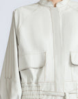 Zoe Jacket in Silver – 100% cotton jacket with flap patch pockets, hidden buttons, long sleeves, and an adjustable drawstring hem.