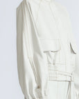 Zoe Jacket in Silver – 100% cotton jacket with flap patch pockets, hidden buttons, long sleeves, and an adjustable drawstring hem.