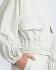 Zoe Jacket in Silver – 100% cotton jacket with flap patch pockets, hidden buttons, long sleeves, and an adjustable drawstring hem.