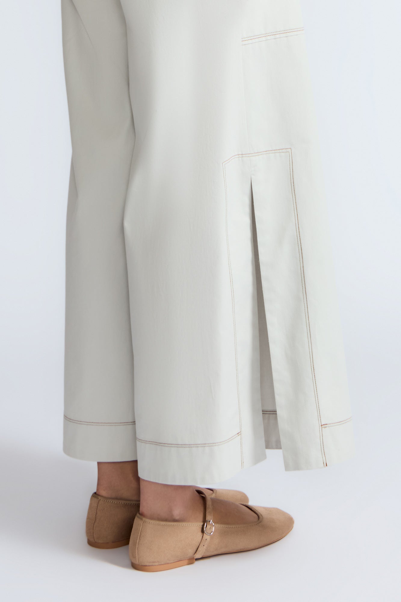 Zoe Pant in Silver – High-waisted cotton pants with front and back patch pockets, wide legs, contrast stitching, and side vents.