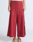 Zoe Pant in Wine – High-waisted wide-leg pants with front and back patch pockets, contrast stitching, and side vents.