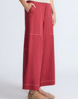 Zoe Pant in Wine – High-waisted wide-leg pants with front and back patch pockets, contrast stitching, and side vents.