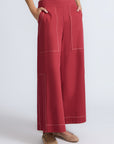 Zoe Pant in Wine – High-waisted wide-leg pants with front and back patch pockets, contrast stitching, and side vents.