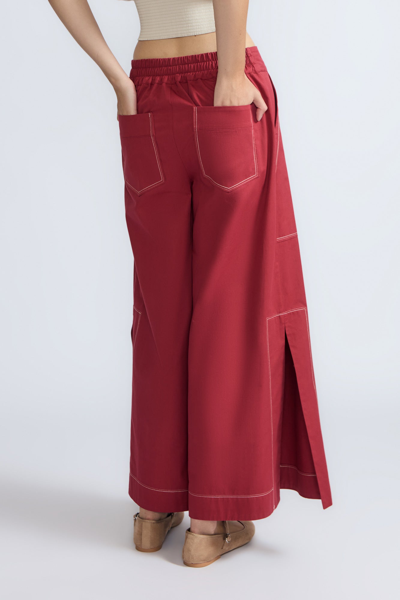 Zoe Pant in Wine – High-waisted wide-leg pants with front and back patch pockets, contrast stitching, and side vents.