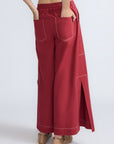 Zoe Pant in Wine – High-waisted wide-leg pants with front and back patch pockets, contrast stitching, and side vents.