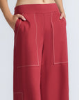Zoe Pant in Wine – High-waisted wide-leg pants with front and back patch pockets, contrast stitching, and side vents.