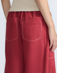 Zoe Pant in Wine – High-waisted wide-leg pants with front and back patch pockets, contrast stitching, and side vents.