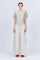 A woman modeling Belén palazzo pants in pristine white color, featuring side patch pockets with metal buckle straps.