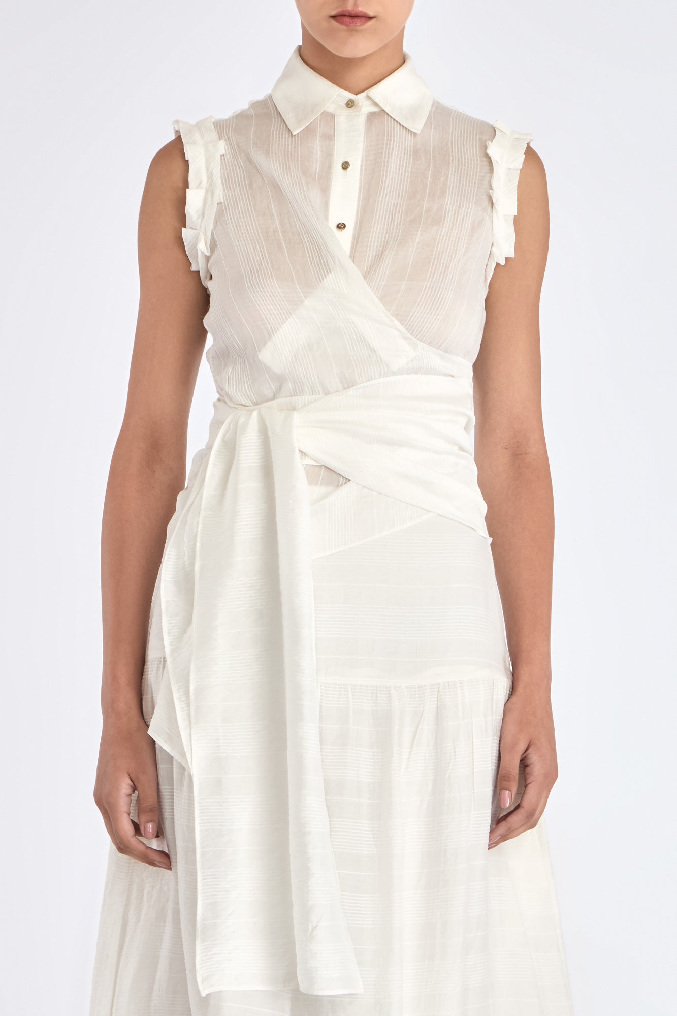 Model wearing the Harlow Wrap Blouse in Off White, showcasing the structured collar and metal button detail.