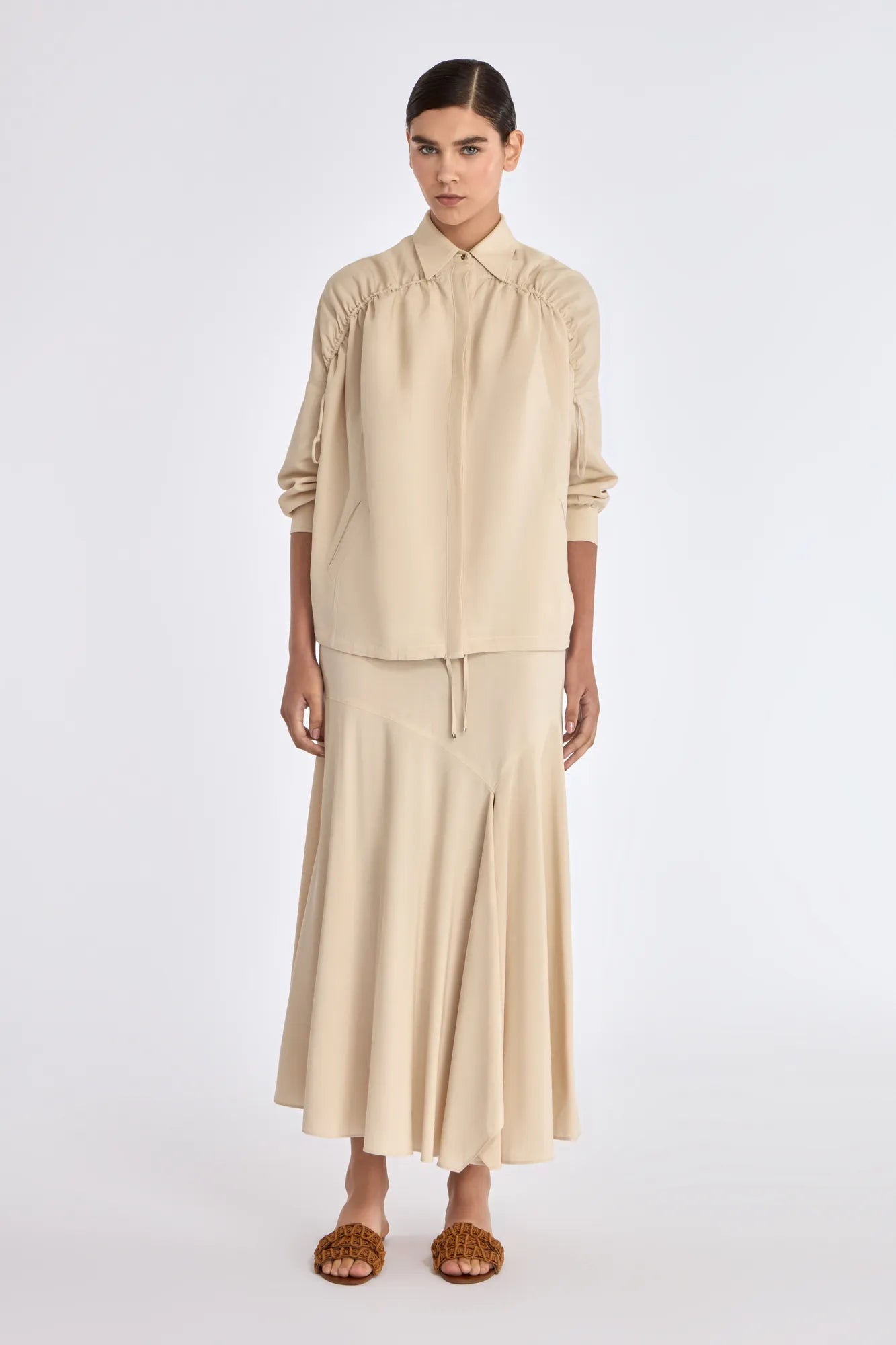 Front view of the Ailani Jacket in a natural Ecru, featuring its unique drawstring placket.
