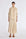 Front view of the Ailani Jacket in a natural Ecru, featuring its unique drawstring placket.
