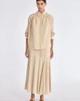 Front view of the Ailani Jacket in a natural Ecru, featuring its unique drawstring placket.