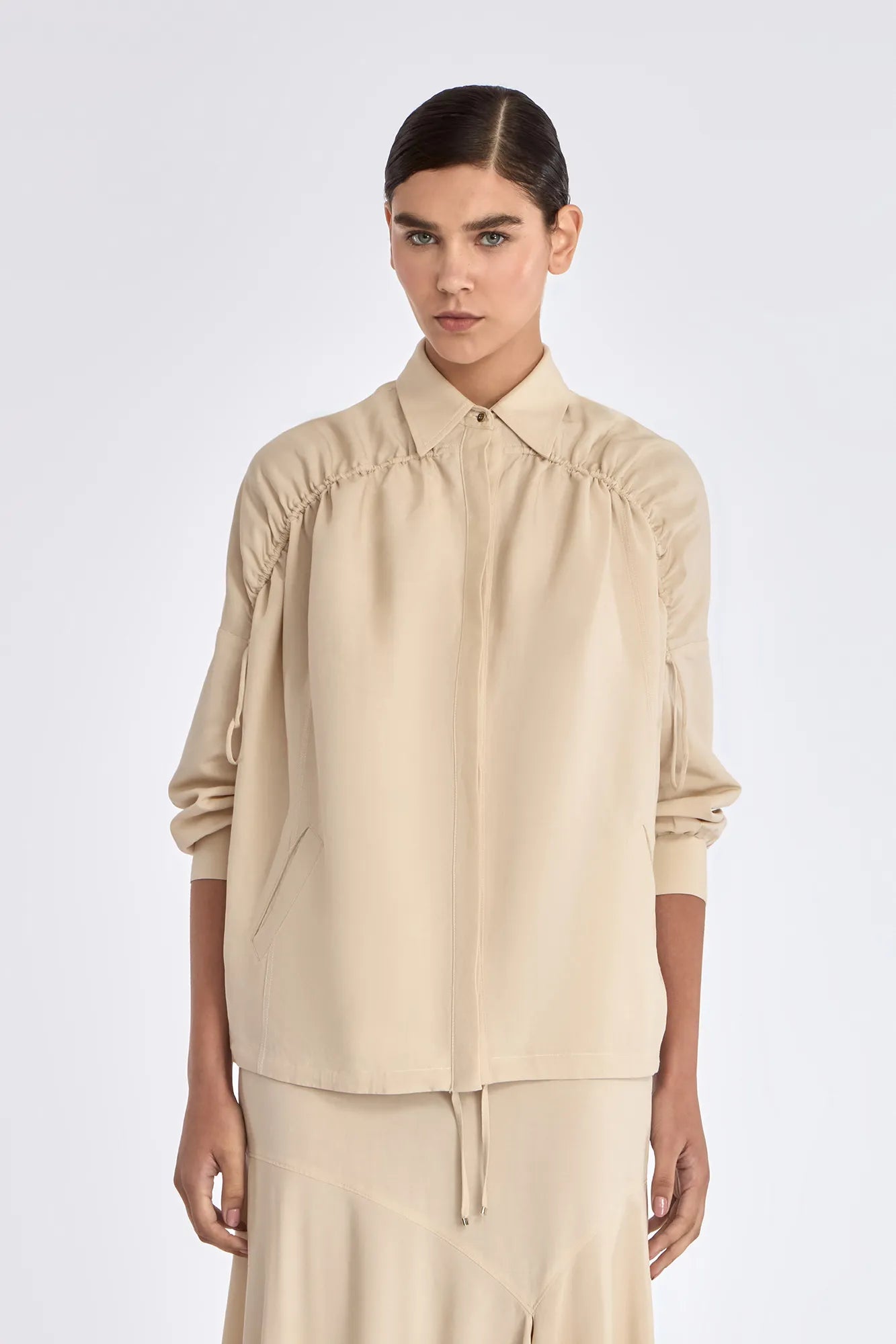 Front view of the Ailani Jacket in a natural Ecru, featuring its unique drawstring placket.