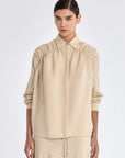 Front view of the Ailani Jacket in a natural Ecru, featuring its unique drawstring placket.