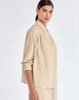 Side profile of the Ecru Ailani Jacket, showing the contrast between the tailored front and soft back.