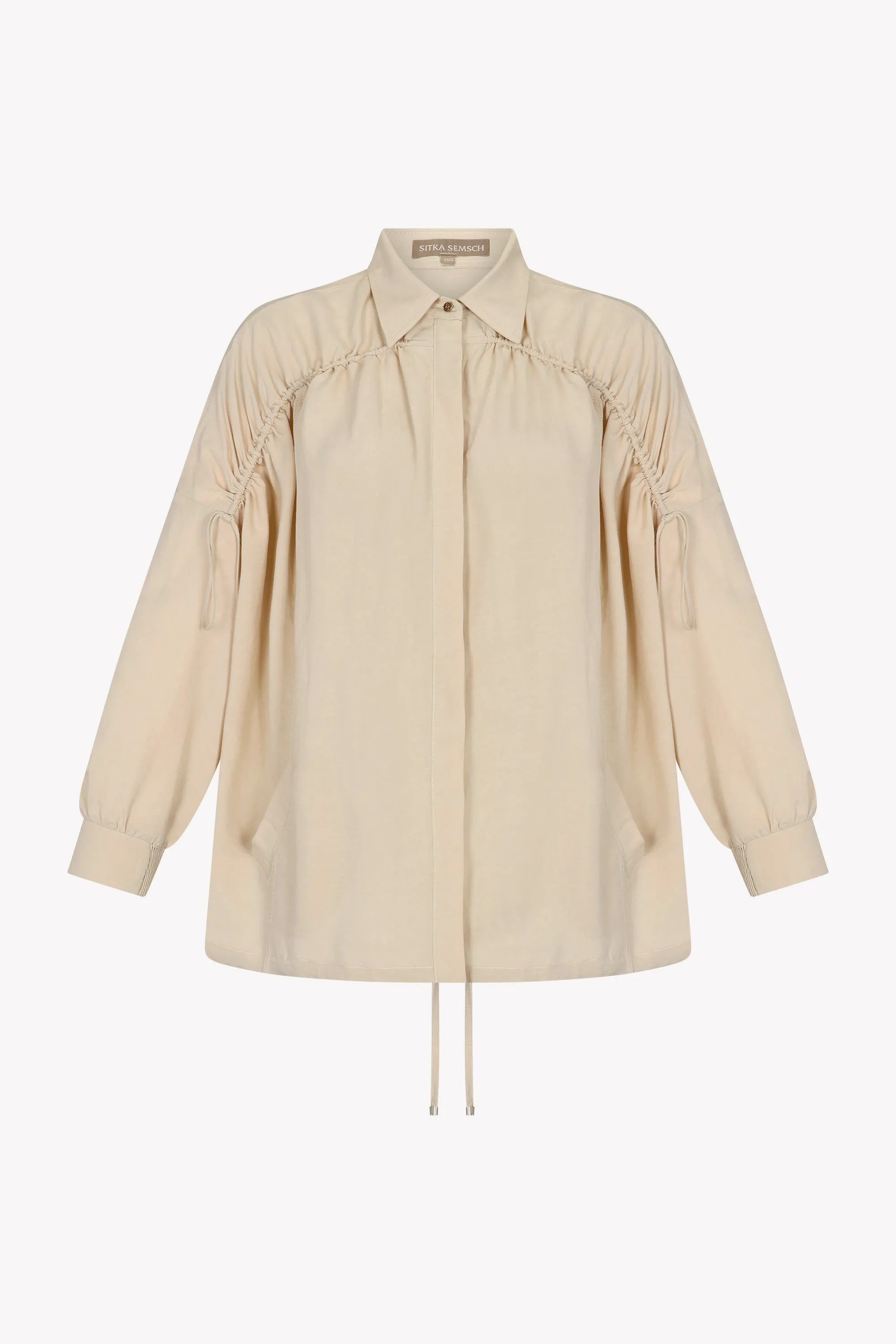 Front view of the Ailani Jacket in a natural Ecru, featuring its unique drawstring placket.
