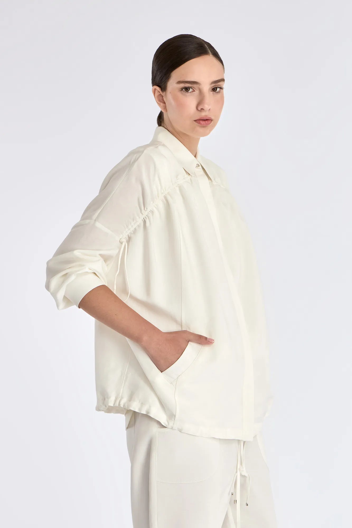 Side view of the Off White Ailani Jacket, showcasing its relaxed yet structured silhouette.