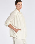 Ailani Jacket in Off White – Viscose-linen shirt collar jacket with hidden pockets, gathered back, and adjustable drawstring placket.