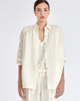 The Ailani Jacket in Off White, highlighting its clean architectural lines and drawstring detail.