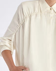 Detail shot of the polished metal button and linen blend texture on the Off White Ailani Jacket.