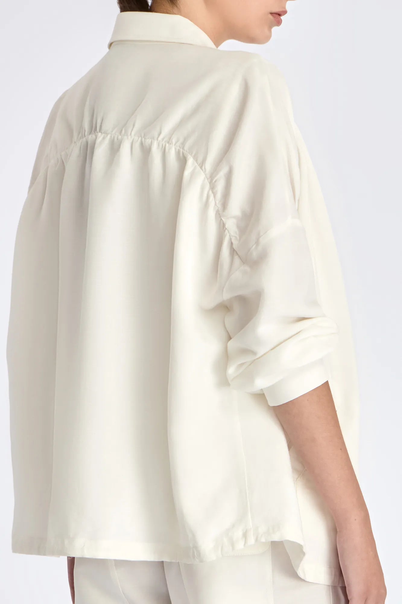 The soft volume of the gathered back panel on the Ailani Jacket in Off White.