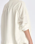 The soft volume of the gathered back panel on the Ailani Jacket in Off White.
