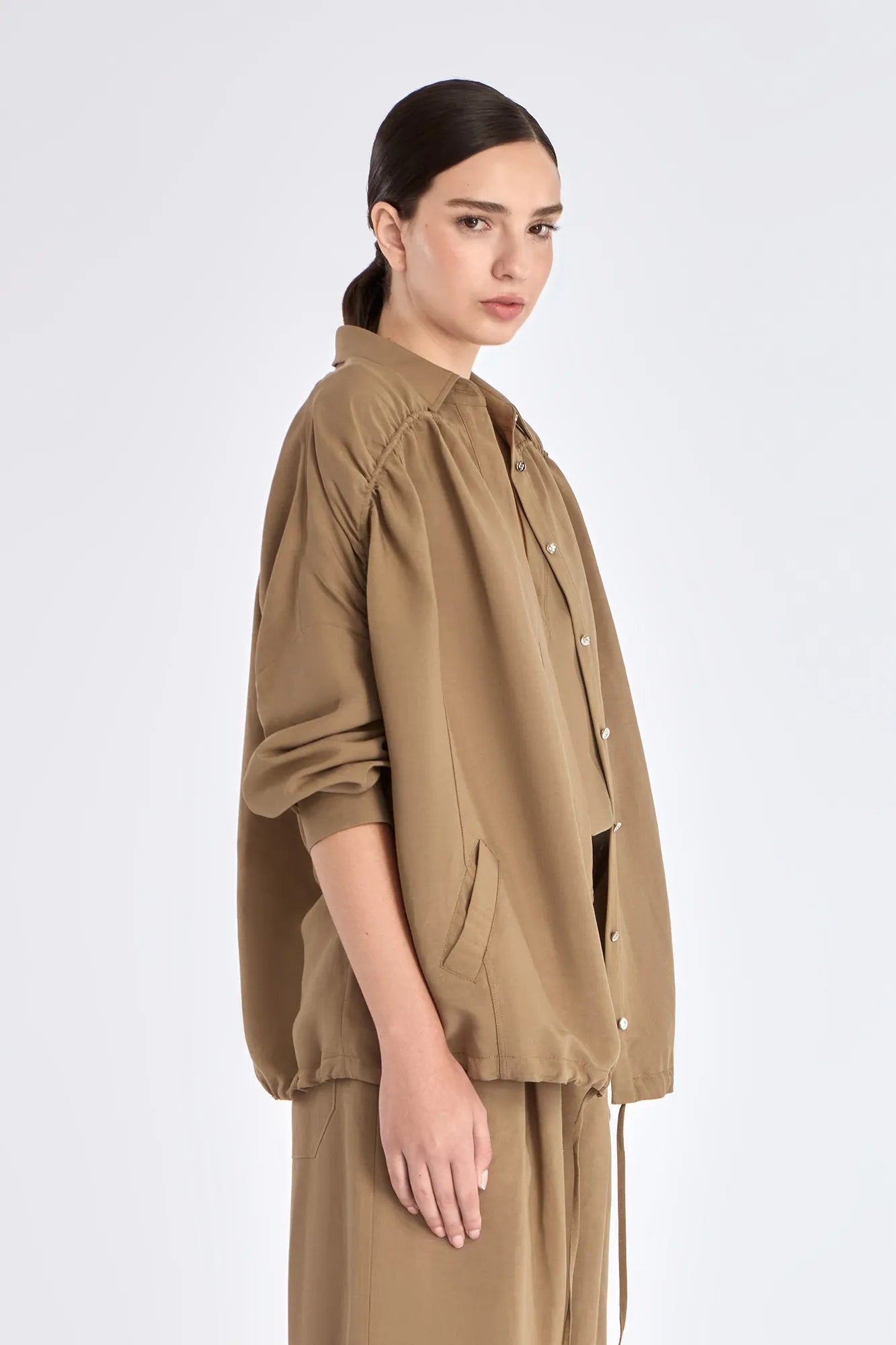 Side profile of the Taupe Ailani Jacket, highlighting the drape of the premium linen blend.