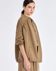 Side profile of the Taupe Ailani Jacket, highlighting the drape of the premium linen blend.