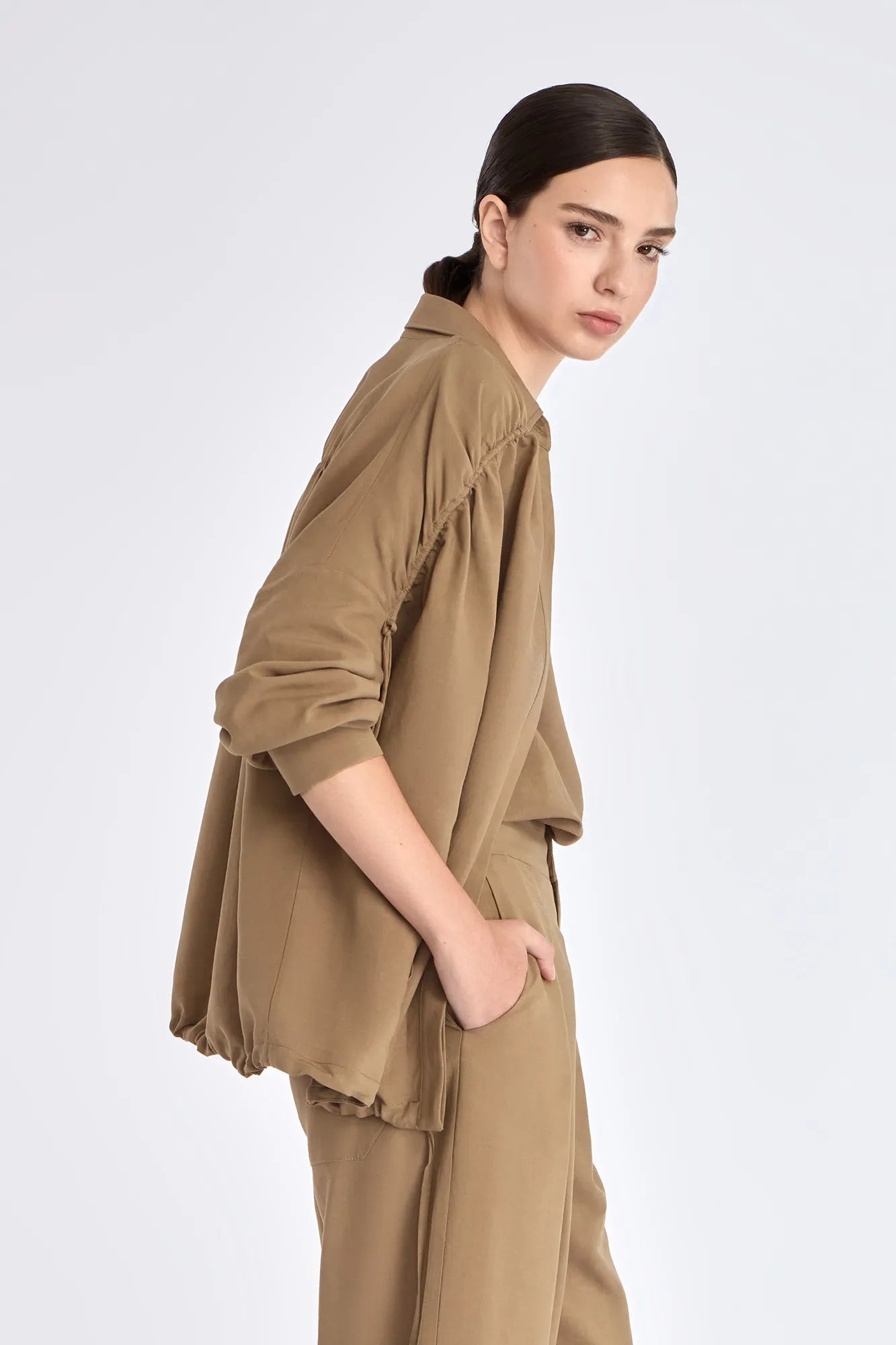 Side profile of the Taupe Ailani Jacket, highlighting the drape of the premium linen blend.