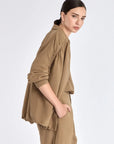 Side profile of the Taupe Ailani Jacket, highlighting the drape of the premium linen blend.