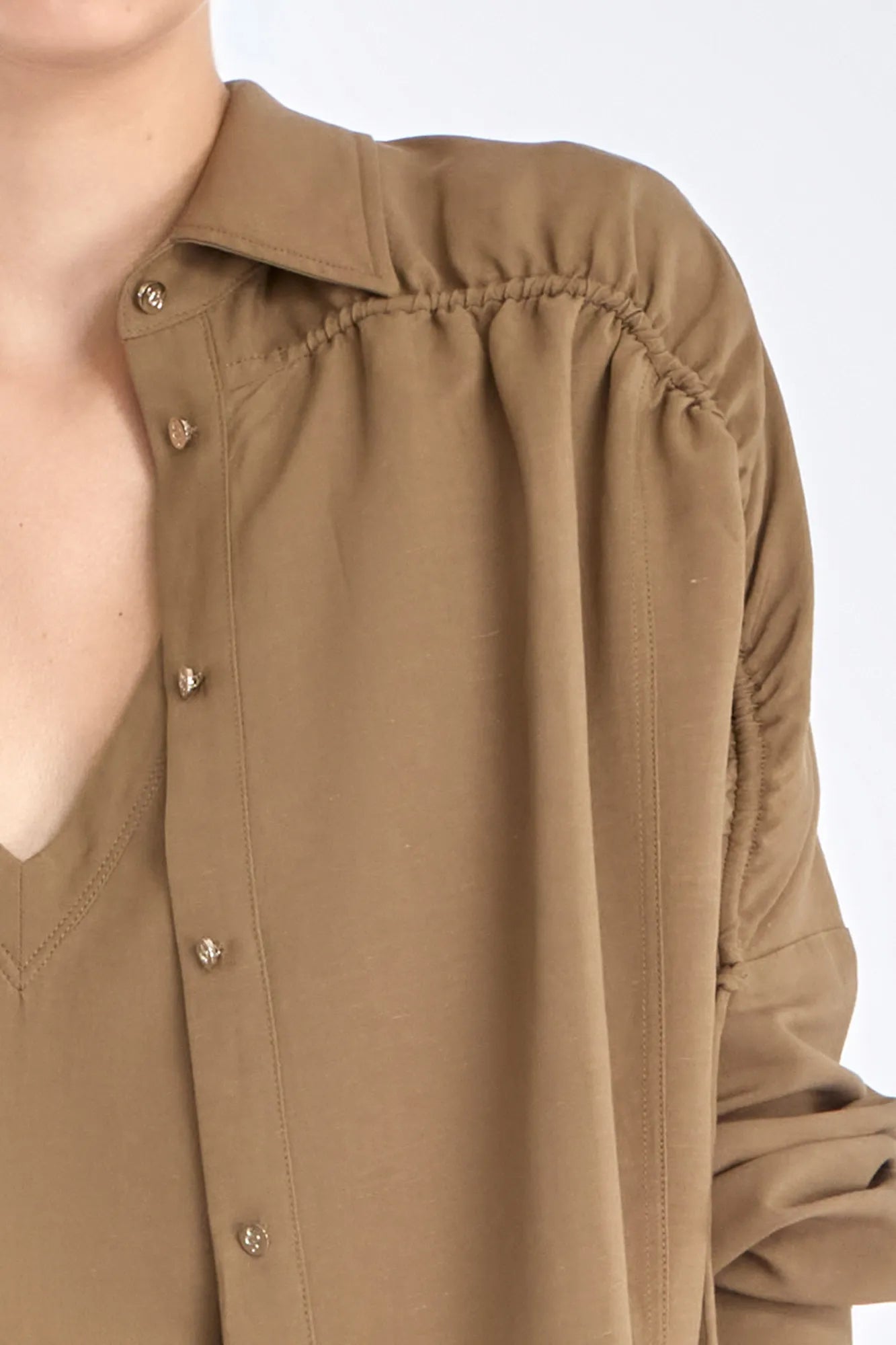 Close-up of the Ailani Jacket in Taupe, showcasing its unique drawstring placket.
