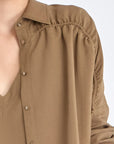 Close-up of the Ailani Jacket in Taupe, showcasing its unique drawstring placket.