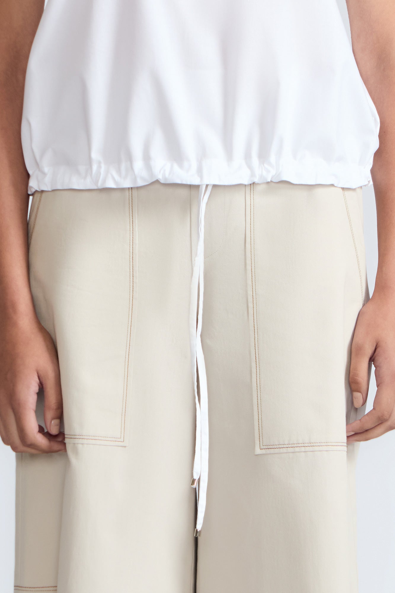 Amara blouse in white with broderie appliques and adjustable drawstring