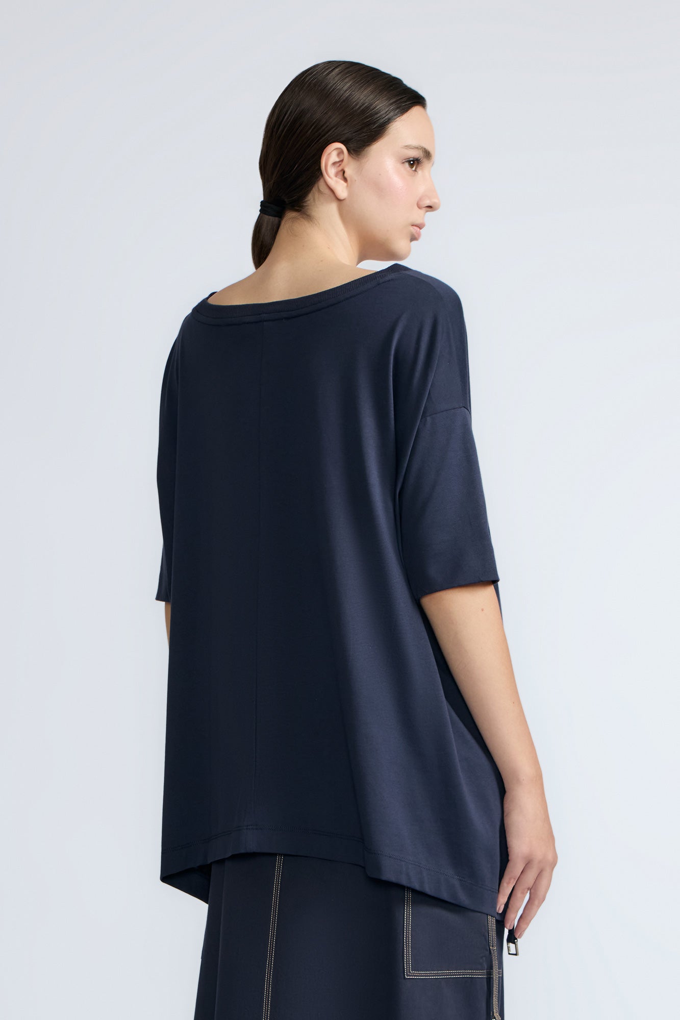 Amaya Top in Navy – Casual-chic cotton top with asymmetrical hem and hem pullers for versatile styling.