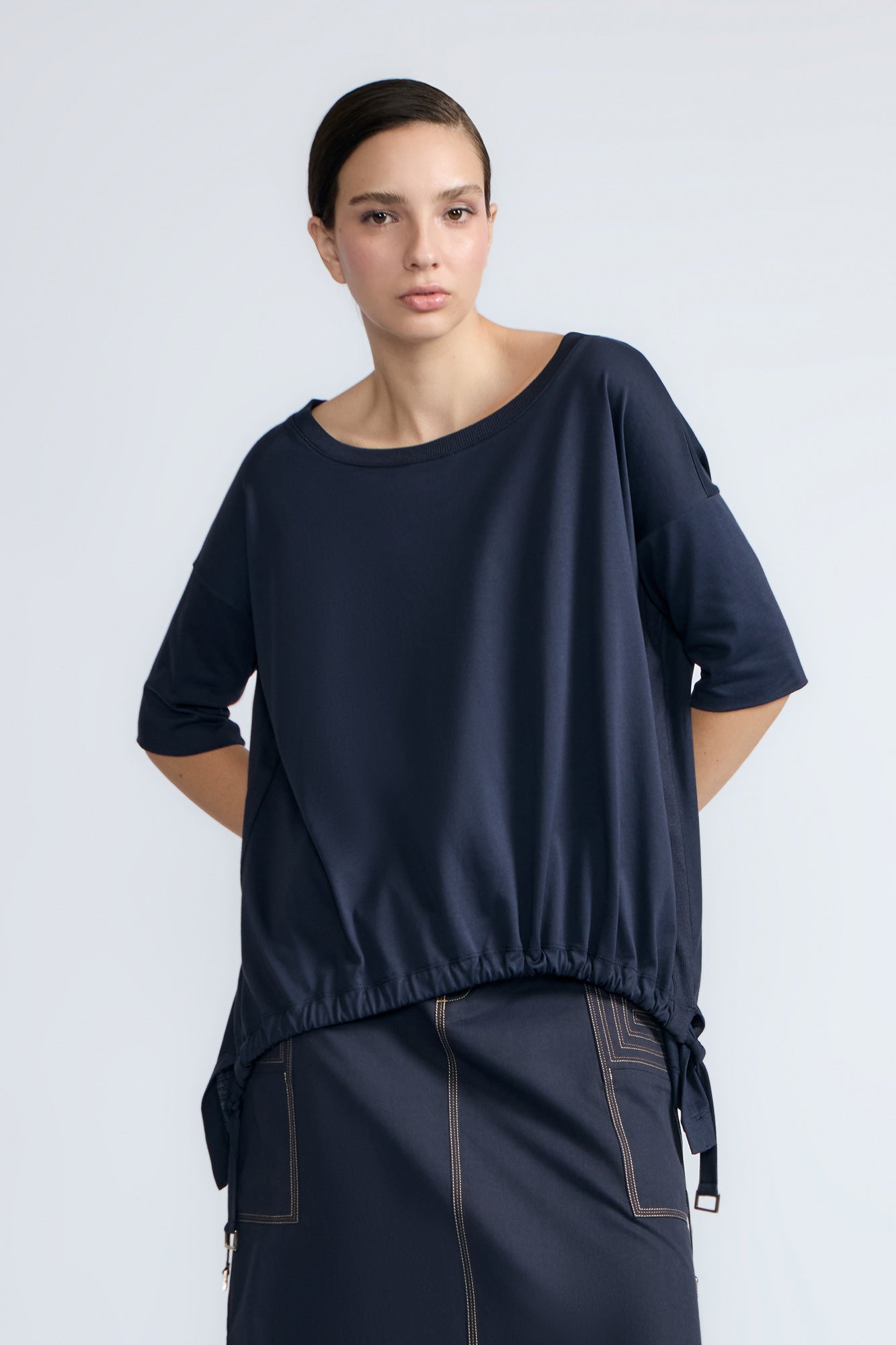 Amaya Top in Navy – Casual-chic cotton top with asymmetrical hem and hem pullers for versatile styling.