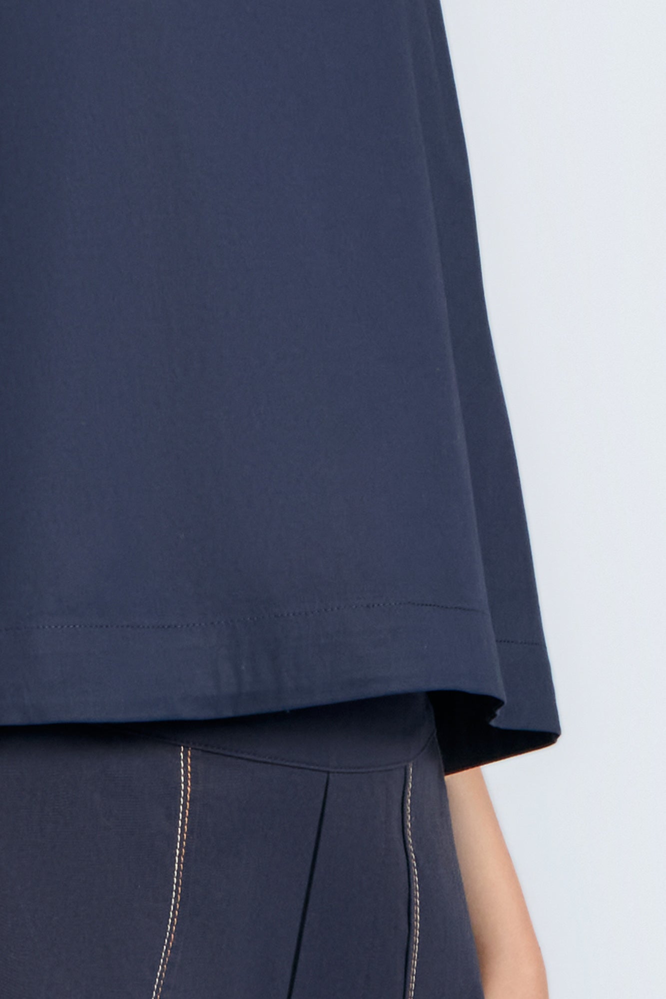 Avayah Top in Navy – 100% cotton sleeveless top with round neckline, shoulder button accents, and drawstring hem.
