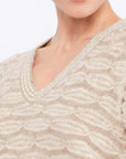 Close-up of the exquisite, handcrafted crochet openwork on the ruffle sleeve of the Beige Melange Beca Vest.