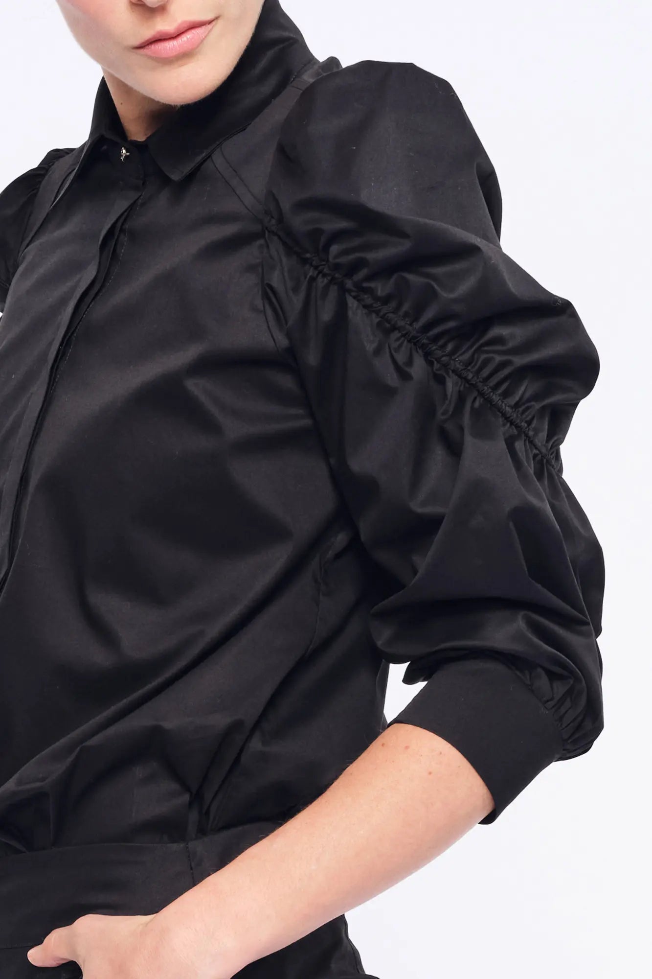 Close-up of the wide, semi-elastic cuff that defines the puff sleeve on the black Bimba Blouse.