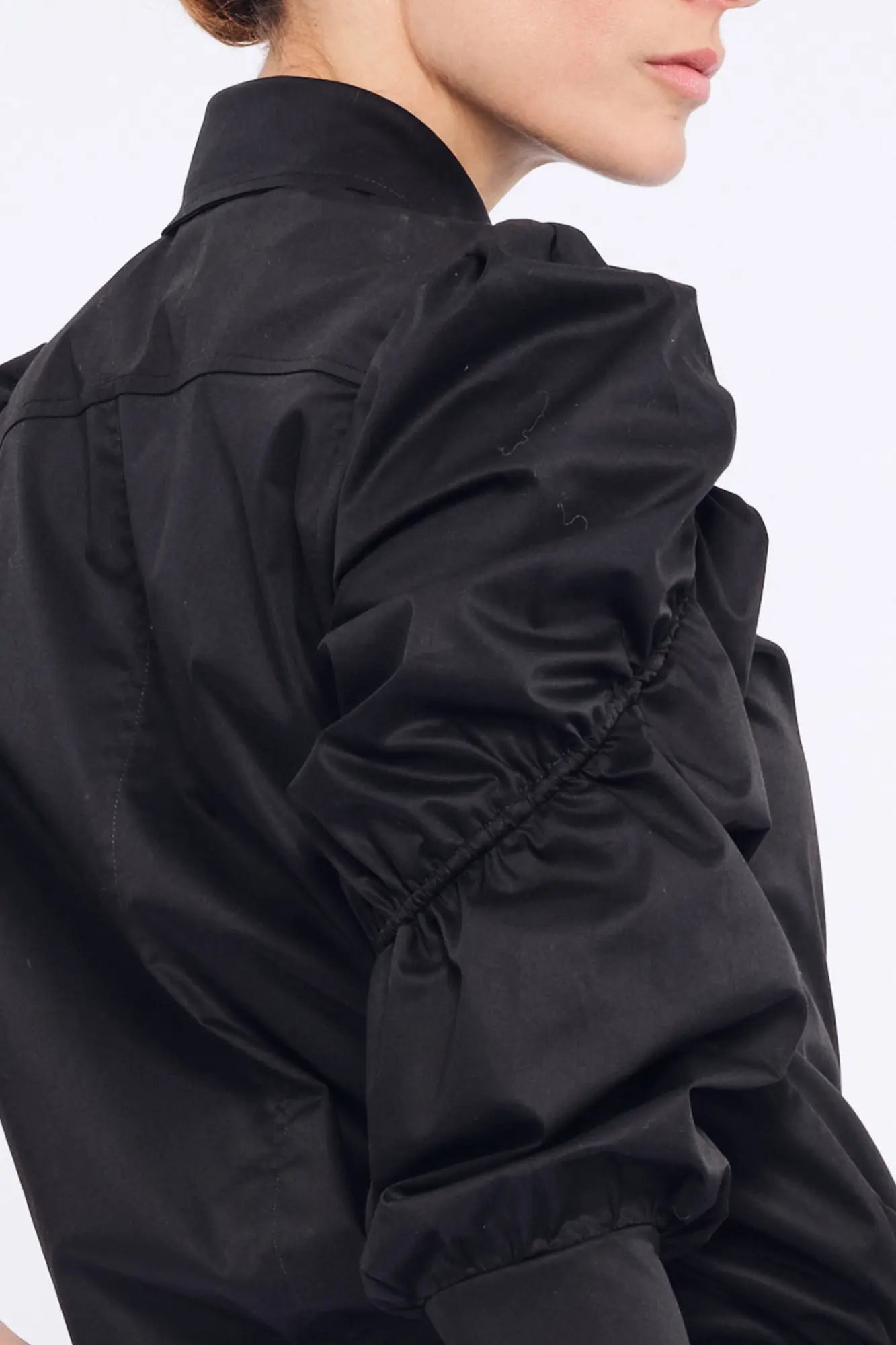 Close-up of the wide, semi-elastic cuff that defines the puff sleeve on the black Bimba Blouse.