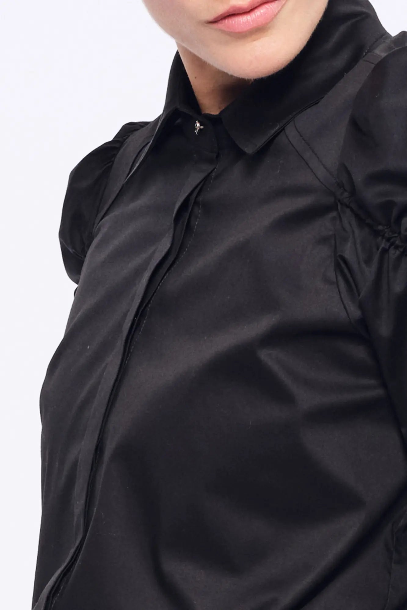 Front view of the Bimba Blouse in essential black, showcasing its powerful, elegant silhouette.