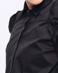 Front view of the Bimba Blouse in essential black, showcasing its powerful, elegant silhouette.
