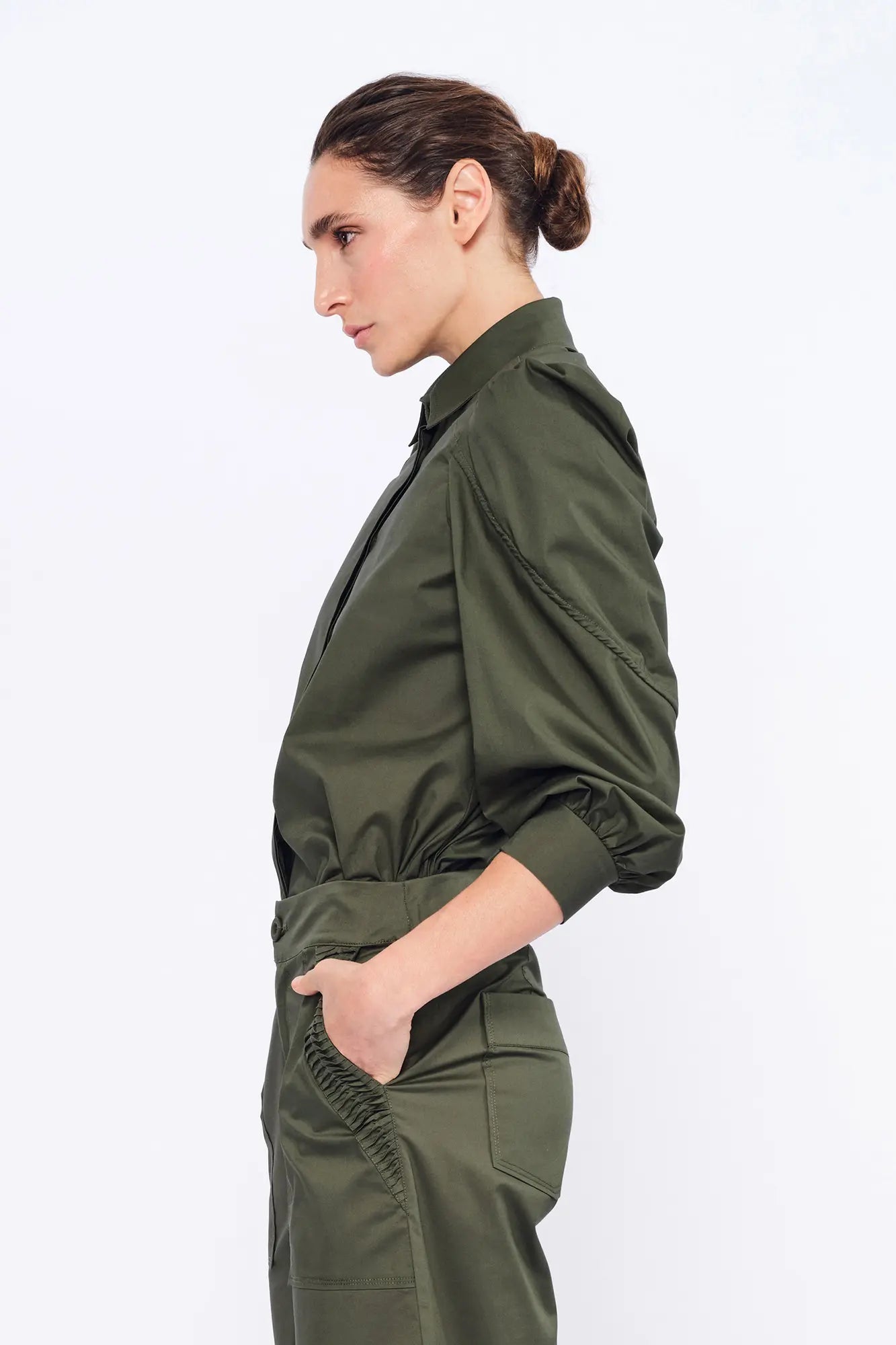 Side profile of the Olive Bimba Blouse, highlighting the dramatic volume of the puff sleeves.