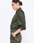Side profile of the Olive Bimba Blouse, highlighting the dramatic volume of the puff sleeves.