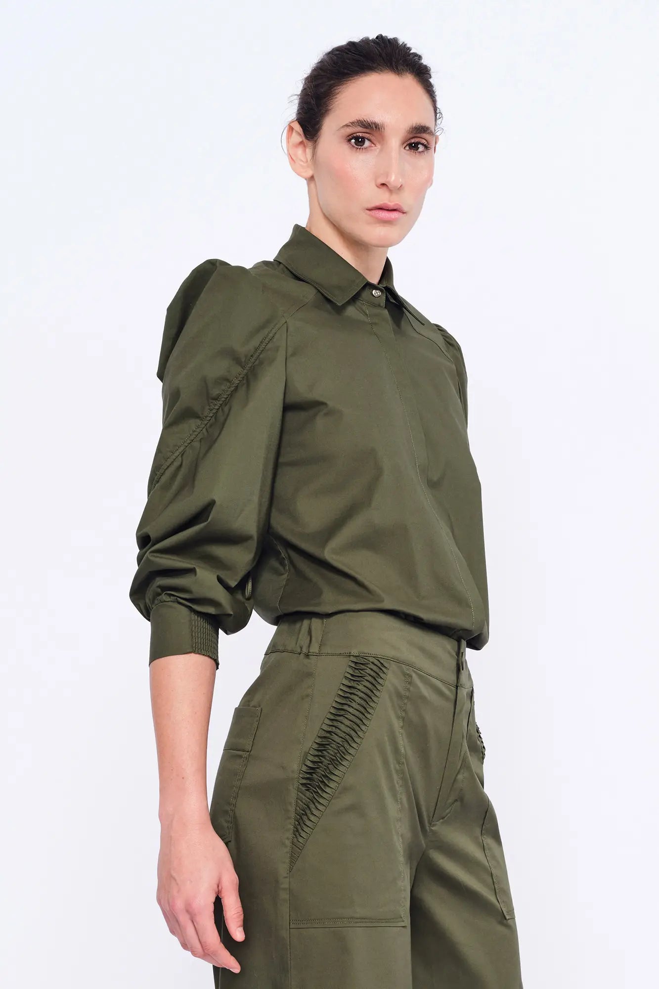 Side profile of the Olive Bimba Blouse, highlighting the dramatic volume of the puff sleeves.