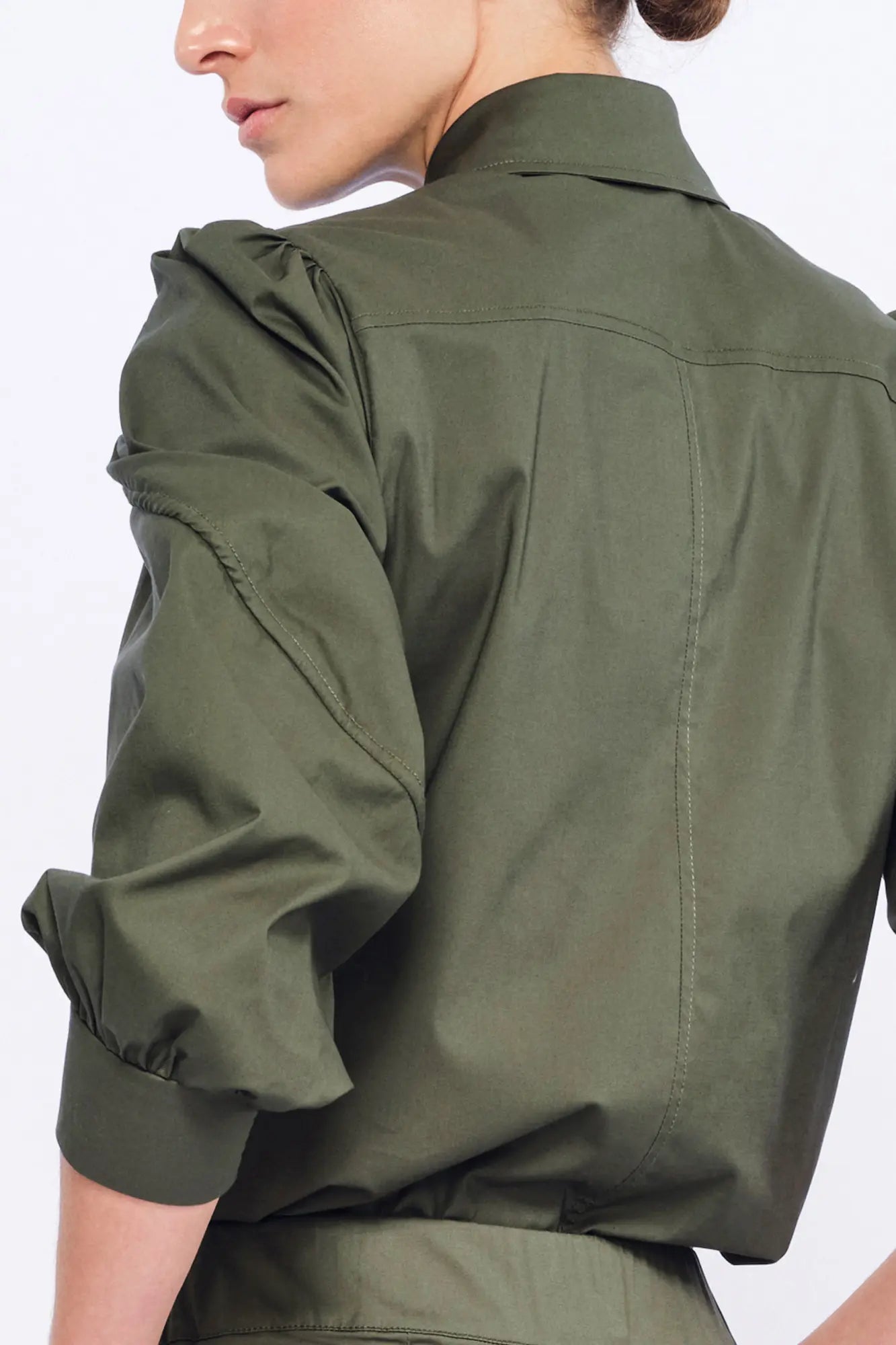 Clean back silhouette of the Bimba Blouse, showing the elegant drape of the stretch cotton.